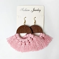 Bohemian earrings with pink cotton fringe and dark brown wood in a flat lay view - Pink