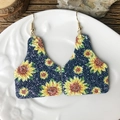 Close-up of cattle tag earrings with sunflower print on white ceramic tray - Bull Ear Tag Sunflower-Blue Glitter (3)
