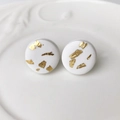Macro view of handmade white clay stud earrings with elegant gold foil marbling effect - White (1)