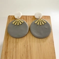 Detailed view of handmade polymer clay earrings with gray discs and gold metal accents - Geometric Round Dangle Style / Gray