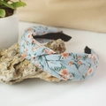 Detailed close-up of light blue floral fabric twist knot headband with pink flowers - Knot Style / Light Blue Floral (1)