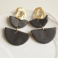 Detail view of geometric clay earrings with gold hammered metal and matte black semicircles - Black