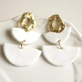Modern geometric handmade clay earrings with gold textured rings on white porcelain - White