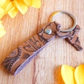 Detail of vintage embossed brown leather keychain with a horse charm on a wooden background - Brown Floral Embossed Horse Style (2)