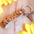 Detail of vintage bull head pendant and tiger print leather keychain on wood - Brown Tiger Print Bull Head Style (3)