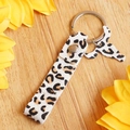 Detail view of leopard print leather keychain with bull head charm and silver metal ring - Leopard Print Style