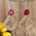 Macro detail of Bohemian woven rattan square earrings with red clay studs on wood - Red Disc Square Rattan Style (2)