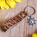 Detailed view of leather sunflower keychain with western embossed texture and metal ring - Brown Leopard Texture (3)
