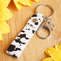 Detail of cow print cowhide leather keychain with silver snap button and lobster clasp - Cow Style