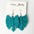 Handmade bohemian teal macrame tassel earrings in leaf design on white card - Cyan Blue