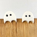 Close-up of cute white ghost-shaped clay earrings with black eyes on a wooden stand - Ghost (4)