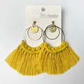 Detail of bright yellow hand-woven tassel earrings with bohemian metal rings on white card - Yellow