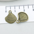 Macro detail of antique bronze seashell pendant with size scale and metallic texture - Shell (3478)