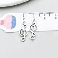 Primer plano de dos colgantes de clave de sol en plata antigua para joyas DIY - Clave de Sol (6401) / 1 Pieza/Paquete (8x20mm) / Plata antigua