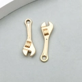 Close-up of gold adjustable wrench pendants for DIY jewelry and keychain accessories - 1 Piece KC Gold Wrench Shape (18330)