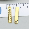 Macro shot of 3cm vintage gold ruler charm with scale details and top hanging ring - Antique Gold Ruler (20240)
