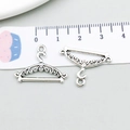 Macro view of hanger-shaped antique silver alloy charm with ornate carvings and scale ruler - Antique Silver Hanger Style (4863)