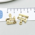 Macro view of antique gold sewing machine pendant showing exact dimensions on ruler - Antique Gold Sewing Machine Style (20224)