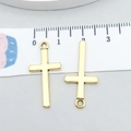 Two pieces of bright gold alloy hollow cross pendants with measurement scale shown - Antique Gold Cross 27x13mm (20374)