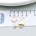 Macro detail of pink enamel heart key pendants measured with a centimeter scale - Pink Enamel Heart Key (10989) / 7x16mm