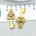 Detail view of two antique gold alloy heart key charms with size ruler reference - Antique Gold Key (11117)