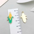 Detail of yellow enamel corn pendant with cute smiley face and metallic gold back texture - Thanksgiving Corn (19198) / 1 Piece (23x12mm) / Yellow