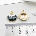 Detail of alloy shell pendants with black enamel stripes and gold metallic texture back - Shell / Black