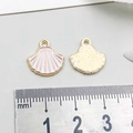 Macro detail of 12mm pink shell alloy pendant with gold plating and enamel finish - Shell / Pink