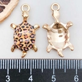 Macro detail of leopard print sea turtle pendant with gold plating and measurement scale - Printed Turtle / Leopard Print