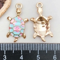 Detailed macro view of colorful enamel turtle charms with scale for size reference - Printed Turtle / Light Blue