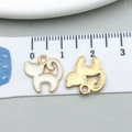 Macro shot of 1.5cm white enamel cat charms for DIY jewelry making with ruler scale - Cat Shape