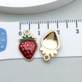 Macro shot of strawberry enamel pendants showing red finish and golden metal back - Red Enamel Strawberry