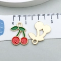 Close-up of red enamel cherry charms with green leaves and gold plated back for DIY jewelry - Red Enamel Cherry