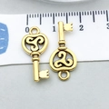 Antique gold finish heart key charms for DIY jewelry making shown with ruler - Antique Gold Key (20951)