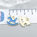Macro shot of light blue enamel rocking horse charms showing size 1.6cm on a white ruler - Rocking Horse (11956) / 1 Piece (16x13mm) / Lake Blue