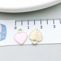 Pink heart enamel charm and golden textured leaf pendant on a white ruler for DIY jewelry - Pink Enamel Heart (15812) / 9x12mm