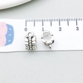 Macro view of 8mm antique silver alloy spacer beads with relief texture and hanging loop - Antique Silver Bail 6x10mm (8279)
