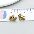 Macro shot of 1cm vintage bronze hollow jewelry connector with ruler measurement - Antique Gold Hollow Cylinder (14330)