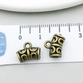 Detailed view of bronze alloy spacer bead with hollow patterns measured on a white scale - Antique Bronze Semi-circle (20665)