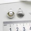 Silver shell-shaped metal pendant with white pearl inlay and size measurement scale - Pearl Shell / White