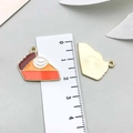 Enameled pumpkin pie alloy charm for DIY jewelry making shown with metric ruler - Thanksgiving Cake (19197) / 1 Piece Pack (19x20mm) / Orange