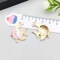 Detail showing front and back of pink fish alloy pendant with golden edges for jewelry DIY - Tropical Fish / Pink