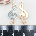 Close-up of treble clef enamel pendants with measuring ruler showing 25mm height - Lake Blue Enamel Music Symbol (9*21mm)