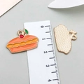 Enamel pie pendant in orange and yellow with a textured golden metal back - Fruit Cake (19341)