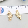 Pair of gold-plated seahorse charms with precise scale measurement showing 22mm height - KC Gold Seahorse Style (18255) / 11*23mm