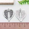 Antique silver heart wing charms for DIY jewelry making shown with measurement tool - Antique Silver Heart Wing (10397)