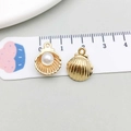 Macro detail of 1.5cm golden shell pendants with pearls for DIY jewelry making - Gold (11948)