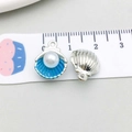 Detailed macro view of 1.5cm shell pendant with blue enamel and a white faux pearl - Lake Blue (14351)