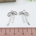Silver bow alloy pendant DIY jewelry accessory shown with scale ruler for size reference - Bowknot (21399)