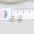 Macro view of a silver heart charm with my DOG engraving and hollow paw print detail - Antique Silver Heart Paw 10x12mm (7277)